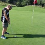 green grass with the flag in the hole.