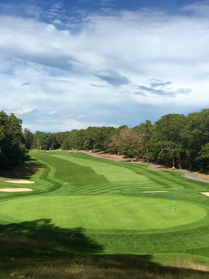 Panoramic view of a lush green golf course at Cape Cod Country Club. Smooth
