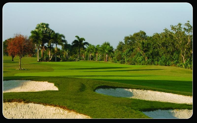 Panoramic view of a lush green golf course at Capri Isles Golf Club. Smooth
