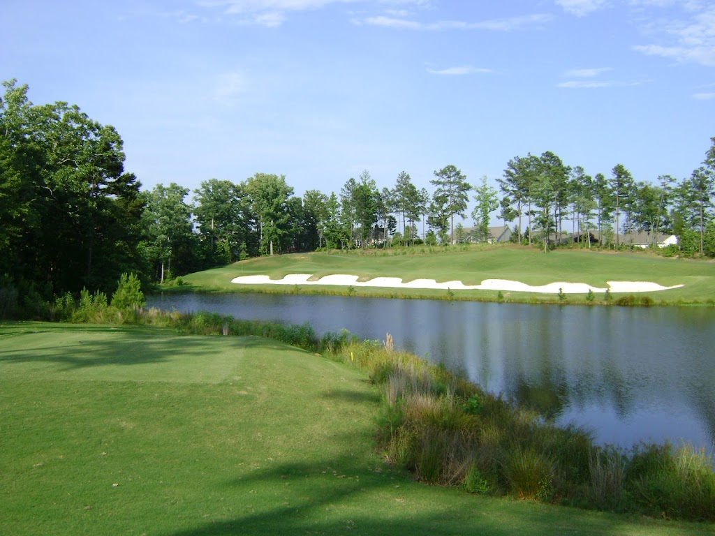 Panoramic view of a lush green golf course at Carolina Lakes Golf Club. Smooth