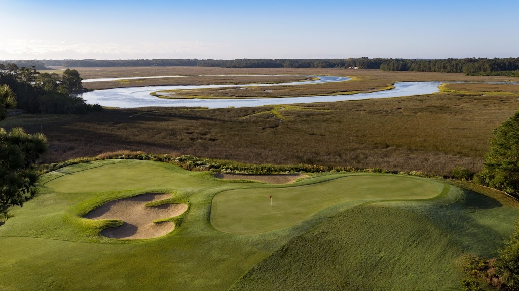 Panoramic view of a lush green golf course at Carolina National Golf Club. Smooth