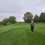 green grass with the flag in the hole.