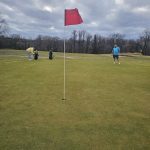 green grass with the flag in the hole.