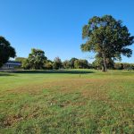 Panoramic view of a lush green golf course at Carroll Park Golf Course. Smooth