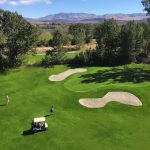Panoramic view of a lush green golf course at Carson Valley Golf Course. Smooth