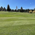 Panoramic view of a lush green golf course at Cascade Golf Course. Smooth
