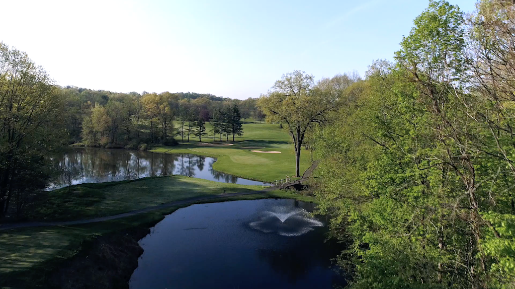 Panoramic view of a lush green golf course at Casperkill Country Club. Smooth