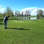 green grass with the flag in the hole.
