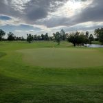 Panoramic view of a lush green golf course at Cave Creek Golf Course. Smooth