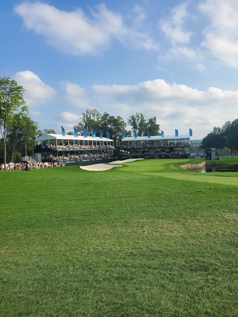 Panoramic view of a lush green golf course at Caves Valley Golf Club. Smooth