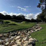 Panoramic view of a lush green golf course at Cedar Creek Golf Course. Smooth