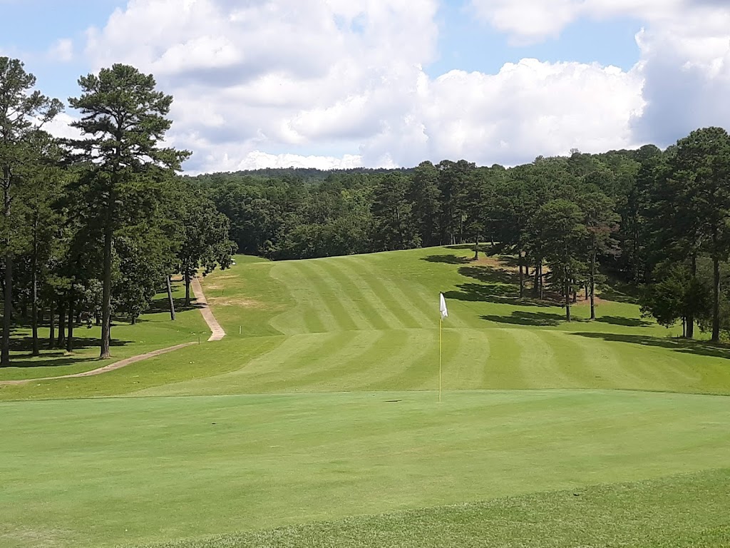 Panoramic view of a lush green golf course at Cedar Creek Golf Course. Smooth