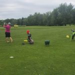 Panoramic view of a lush green golf course at Cedar Creek Golf Course. Smooth