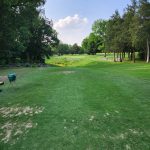 Panoramic view of a lush green golf course at Cedar Crest Golf Club. Smooth