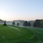 Panoramic view of a lush green golf course at Cedar Knoll Country Club. Smooth