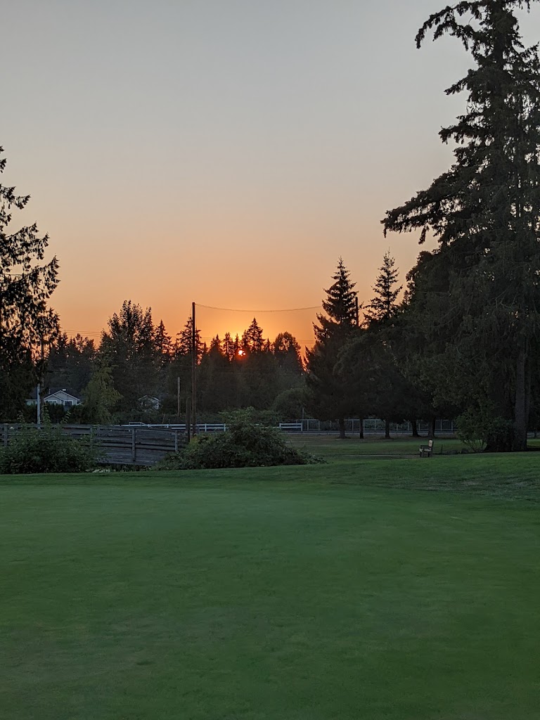 Panoramic view of a lush green golf course at Cedarcrest Golf Course. Smooth