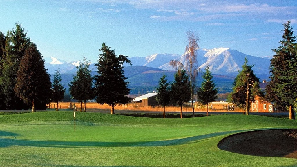 Panoramic view of a lush green golf course at Cedars at Dungeness Golf Course. Smooth