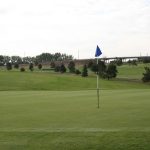 green grass with the flag in the hole.