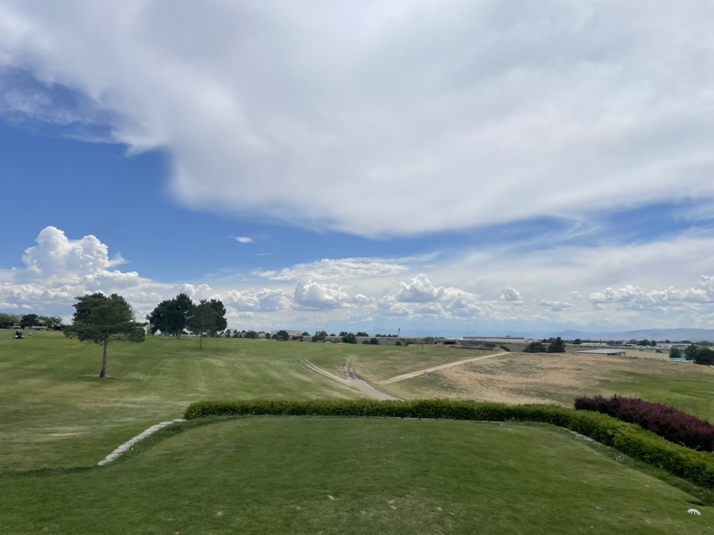Panoramic view of a lush green golf course at Centennial Golf Course. Smooth