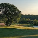 Panoramic view of a lush green golf course at Chalet Hills Golf Club. Smooth