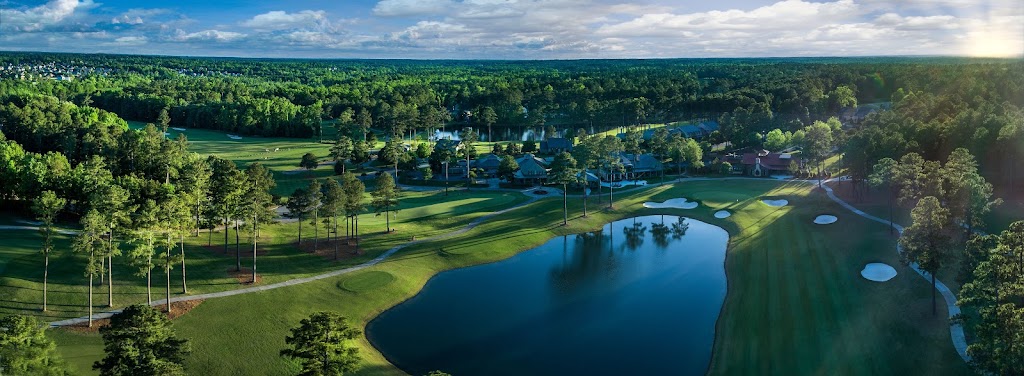 Panoramic view of a lush green golf course at Champions Retreat Golf Club. Smooth