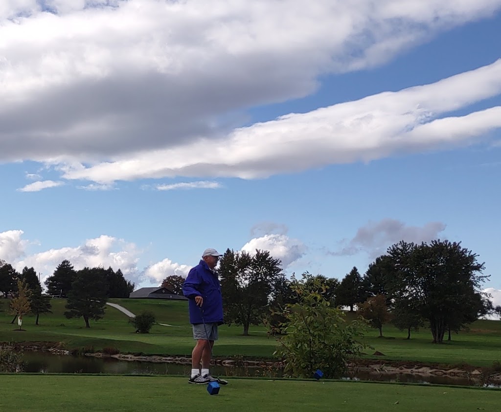 Panoramic view of a lush green golf course at Champlain Country Club. Smooth