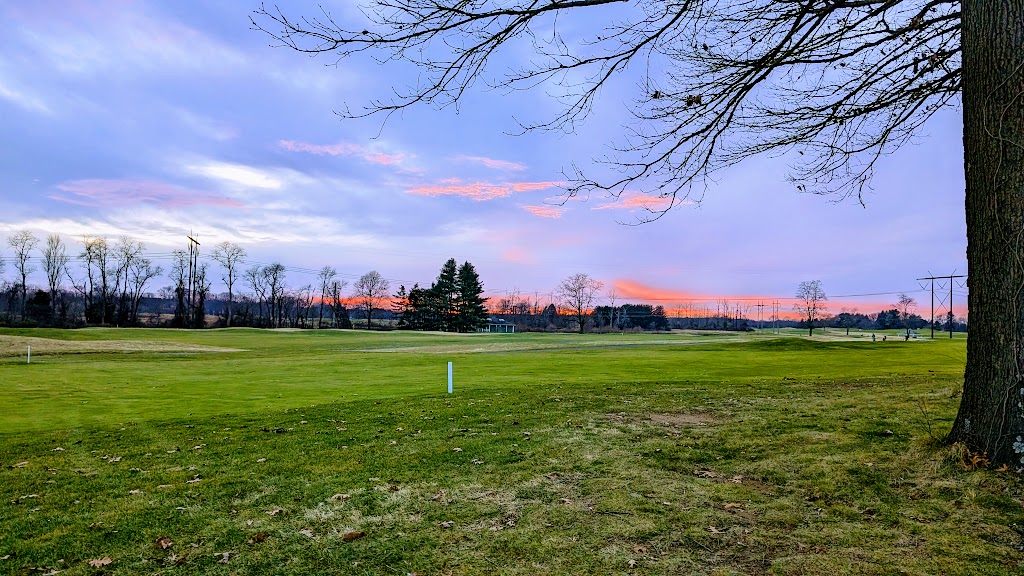 Panoramic view of a lush green golf course at Charleston Springs Golf Course. Smooth