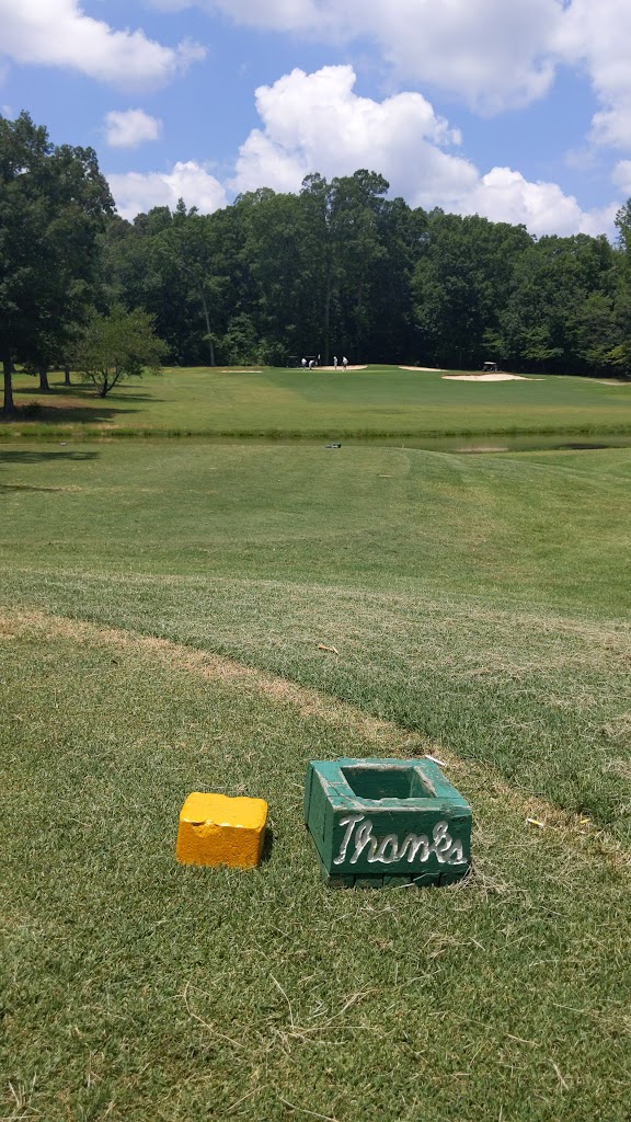 Panoramic view of a lush green golf course at Charlotte National Golf Club. Smooth