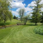 Panoramic view of a lush green golf course at Cheboygan Golf & Country Club. Smooth