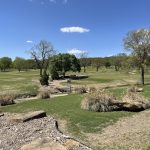 Panoramic view of a lush green golf course at Cherokee Hills Golf Club. Smooth
