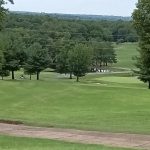 Panoramic view of a lush green golf course at Cherokee Springs Golf Club. Smooth