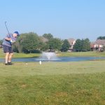 green grass with the flag in the hole.