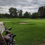 green grass with the flag in the hole.