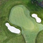green grass with the flag in the hole.