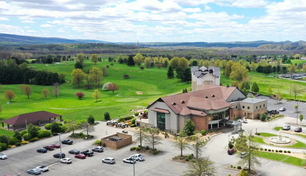 Panoramic view of a lush green golf course at Chestnut Ridge Golf Course. Smooth