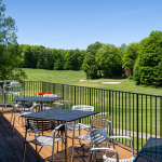 Panoramic view of a lush green golf course at Chestnut Valley Golf Course. Smooth