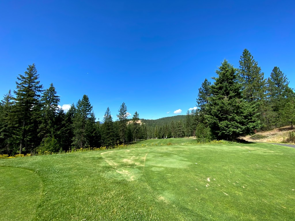 Panoramic view of a lush green golf course at Chewelah Golf & Country Club. Smooth