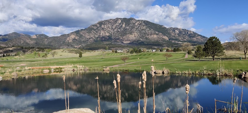 Panoramic view of a lush green golf course at Cheyenne Shadows Golf Club. Smooth