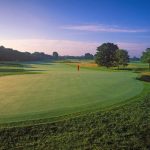 Panoramic view of a lush green golf course at Chicago Golf Club. Smooth