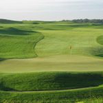 green grass with the flag in the hole.