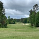 Panoramic view of a lush green golf course at Chickasaw Golf. Smooth