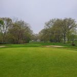 Panoramic view of a lush green golf course at Christopher Morley Park Golf. Smooth