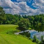 Panoramic view of a lush green golf course at Cider Ridge Golf Club. Smooth