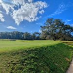 Panoramic view of a lush green golf course at City of Charleston Municipal Golf Course. Smooth