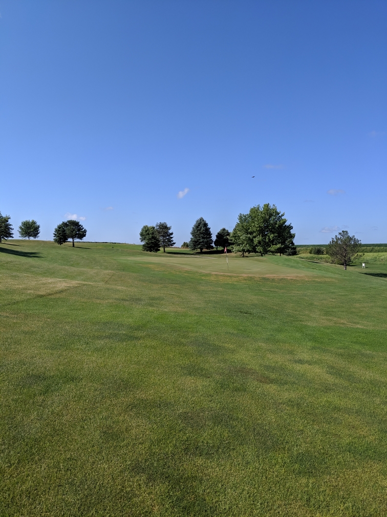 Panoramic view of a lush green golf course at Club 91 Golf Course. Smooth