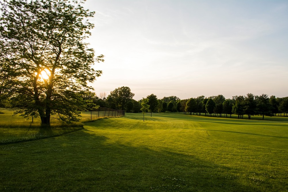 Panoramic view of a lush green golf course at Club Run Golf Course. Smooth