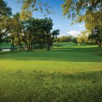 Panoramic view of a lush green golf course at Coachman's Golf Resort Edgerton WI. Smooth