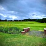 Panoramic view of a lush green golf course at Coakley-Russo Memorial Golf Course. Smooth