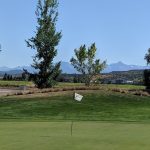 Panoramic view of a lush green golf course at Cobble Creek Golf Club. Smooth