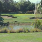 Panoramic view of a lush green golf course at Cobblestone Creek Golf Course. Smooth